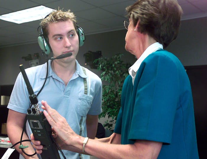 HOUSTON, TX ? AUGUST 27: Soyuz 5 nominated space flight participant and N?Sync member Lance Bass (L) is given HAM radio instructions from Carolynn Conley at Johnson Space Center August 26, 2002 in Houston, Texas. Bass won the endorsements from NASA and other agencies to fly to the space station this fall. A financial agreement still remains to be reached between Bass and the Russian space program. A round trip to the space station will run about $20 million. (Photo by NASA/Getty Images)