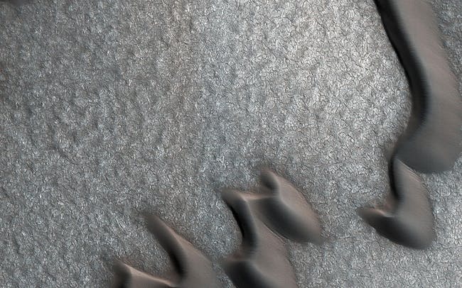 Martian sand dunes and boulder piles.