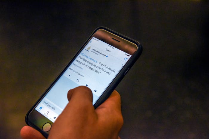 NEW YORK, NY - JUNE 8: A person reads Tweets while watching testimony from former FBI Director James Comey during a Senate Intelligence Committee hearing on Russian interference in the 2016 U.S. election on June 8, 2017 at a restaurant Building on Bond in the Brooklyn borough of New York City. Comey said that President Donald Trump pressured him to drop the FBI's investigation into former National Security Advisor Michael Flynn and demanded Comey's loyalty during the one-on-one meetings he had with president. (Photo by Stephanie Keith/Getty Images)