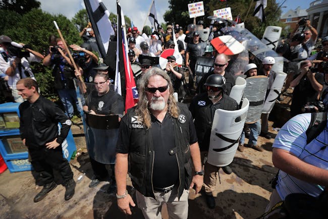 CHARLOTTESVILLE, VA - AUGUST 12: White nationalists, neo-Nazis and members of the 'alt-right' exchange insluts with counter-protesters as they attempt to guard the entrance to Emancipation Park during the 'Unite the Right' rally August 12, 2017 in Charlottesville, Virginia. After clashes with anti-fascist protesters and police the rally was declared an unlawful gathering and people were forced out of Emancipation Park, where a statue of Confederate General Robert E. Lee is slated to be removed. (Photo by Chip Somodevilla/Getty Images)