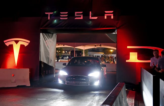 HAWTHORNE CA - OCTOBER 09: Tesla owners take a ride in the new Tesla 'D' model electric sedan after Elon Musk, CEO of Tesla, unveiled the dual engine chassis of the new Tesla 'D' model, a faster and all-wheel-drive version of the Model S electric sedan, at the Hawthorne Airport October 09, 2014 in Hawthorne, California. The D will be able to accelerate to 60 miles per hour in just over 3 seconds. (Photo by Kevork Djansezian/Getty Images)