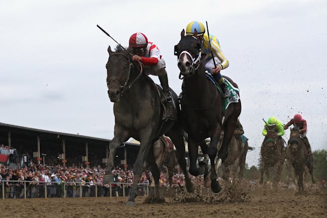 Cloud Computing #2 ridden by Javier Castellano (L) beats Classic Empire #5 ridden by Julien Leparoux to win the 142nd running of the Preakness Stakes at Pimlico Race Course on May 20, 2017 in Baltimore, Maryland.