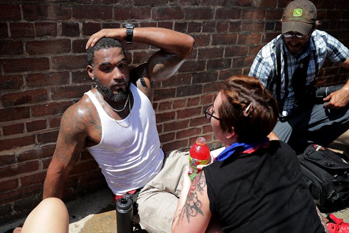 CHARLOTTESVILLE, VA - AUGUST 12: Rescue workers and volunteer medics tend to people who were injured when a car plowed through a crowd of anti-facist counter-demonstrators marching through the downtown shopping district August 12, 2017 in Charlottesville, Virginia. The car plowed through the crowed following the shutdown of the 'Unite the Right' rally by police after white nationalists, neo-Nazis and members of the 'alt-right' and counter-protesters clashed near Lee Park, where a statue of Confederate General Robert E. Lee is slated to be removed. (Photo by Chip Somodevilla/Getty Images)