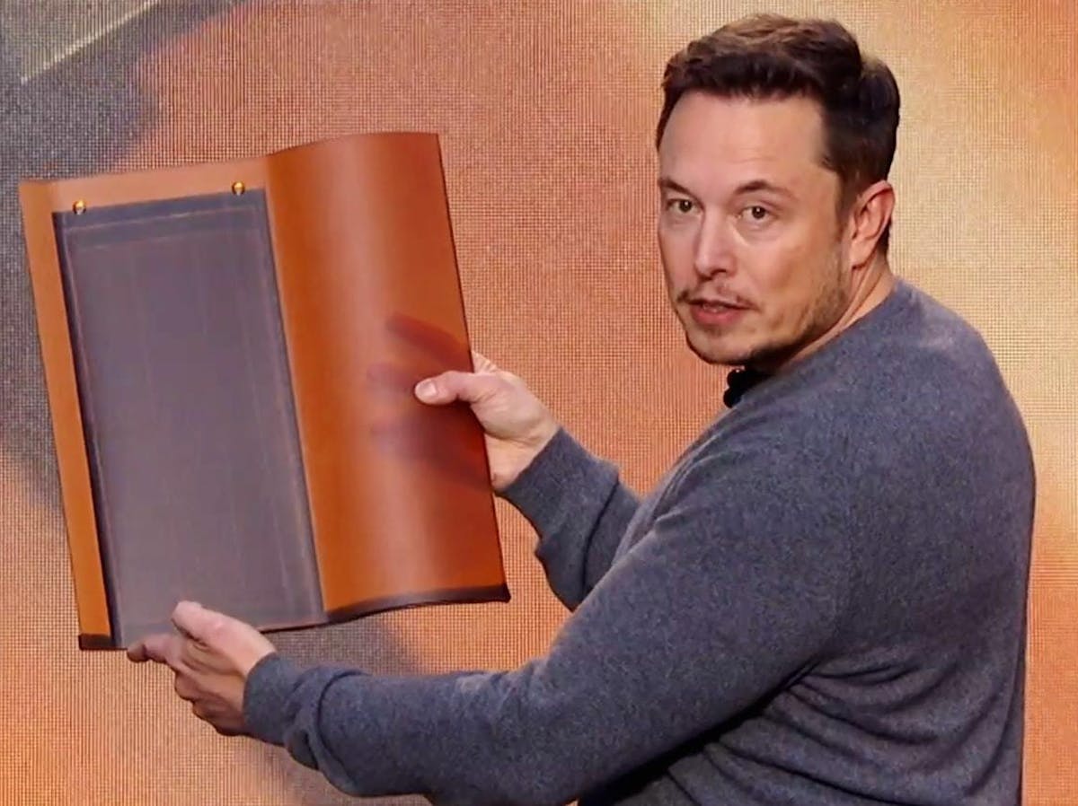 Elon Musk demonstrating the Tesla solar roof in October.