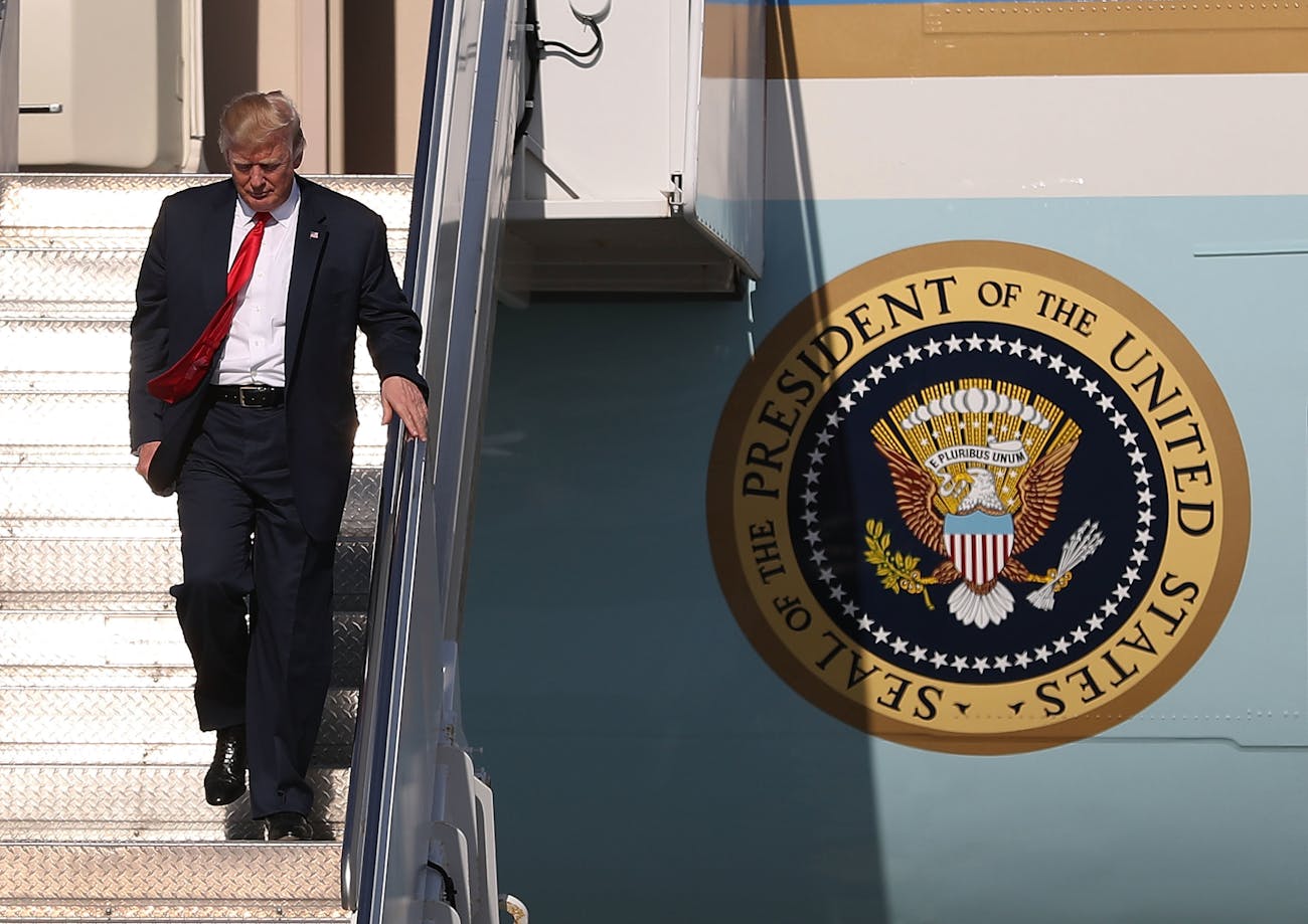 WEST PALM BEACH, FL - FEBRUARY 17: President Donald Trump walks down the stairs after arriving on Air Force One at the Palm Beach International Airport to spend part of the weekend at Mar-a-Lago resort on February 17, 2017 in West Palm Beach, Florida. President Trump is scheduled to have a campaign rally in Melbourne, FL tomorrow. (Photo by Joe Raedle/Getty Images)