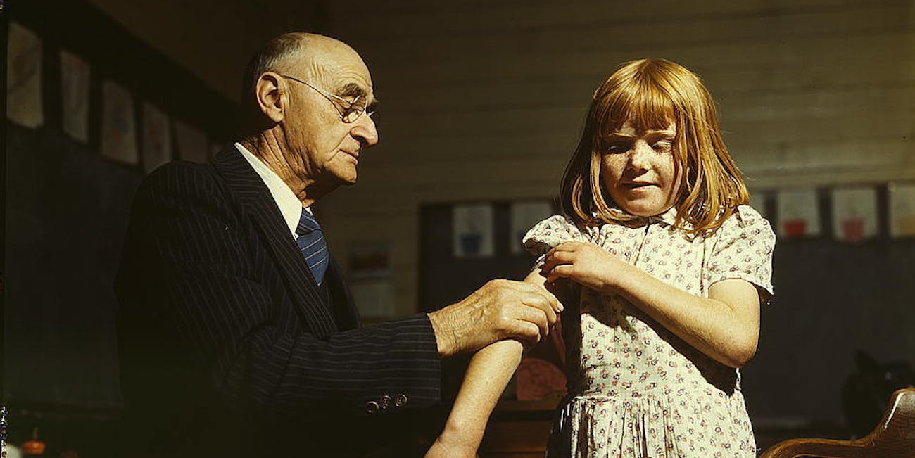 Dr. Schreiber of San Augustine giving a typhoid innoculation at a rural school, San Augustine County, Texas (LOC)