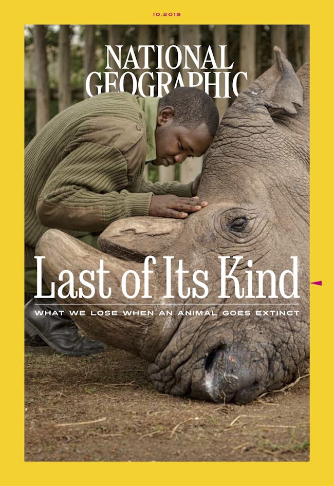 magazine cover shows man embracing elephant
