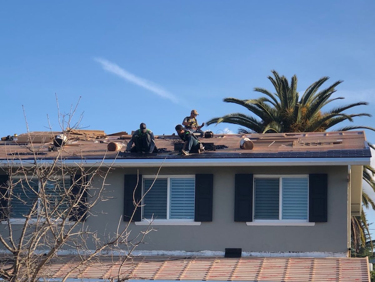 The install team at work in 2018 on Tobler's roof.