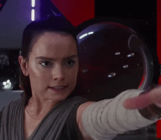 Rey with Kylo Ren's lightsaber.
