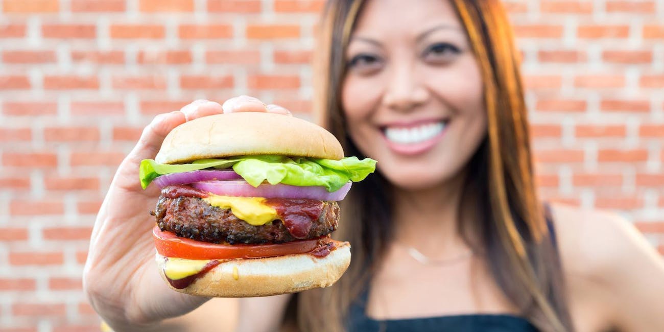 A woman holds the Beyond Burger, a patty made from plant proteins by meat alternative producer Beyond Meat.