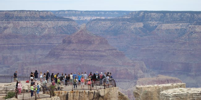 GRAND CANYON NATIONAL PARK, AR - JULY 14: Visitors stand at the Grand Canyon South Rim on July 14, 2014 at Grand Canyon National Park, Arizona. The Grand Canyon is among the state's biggest tourist destinations. (Photo by Sean Gallup/Getty Images)