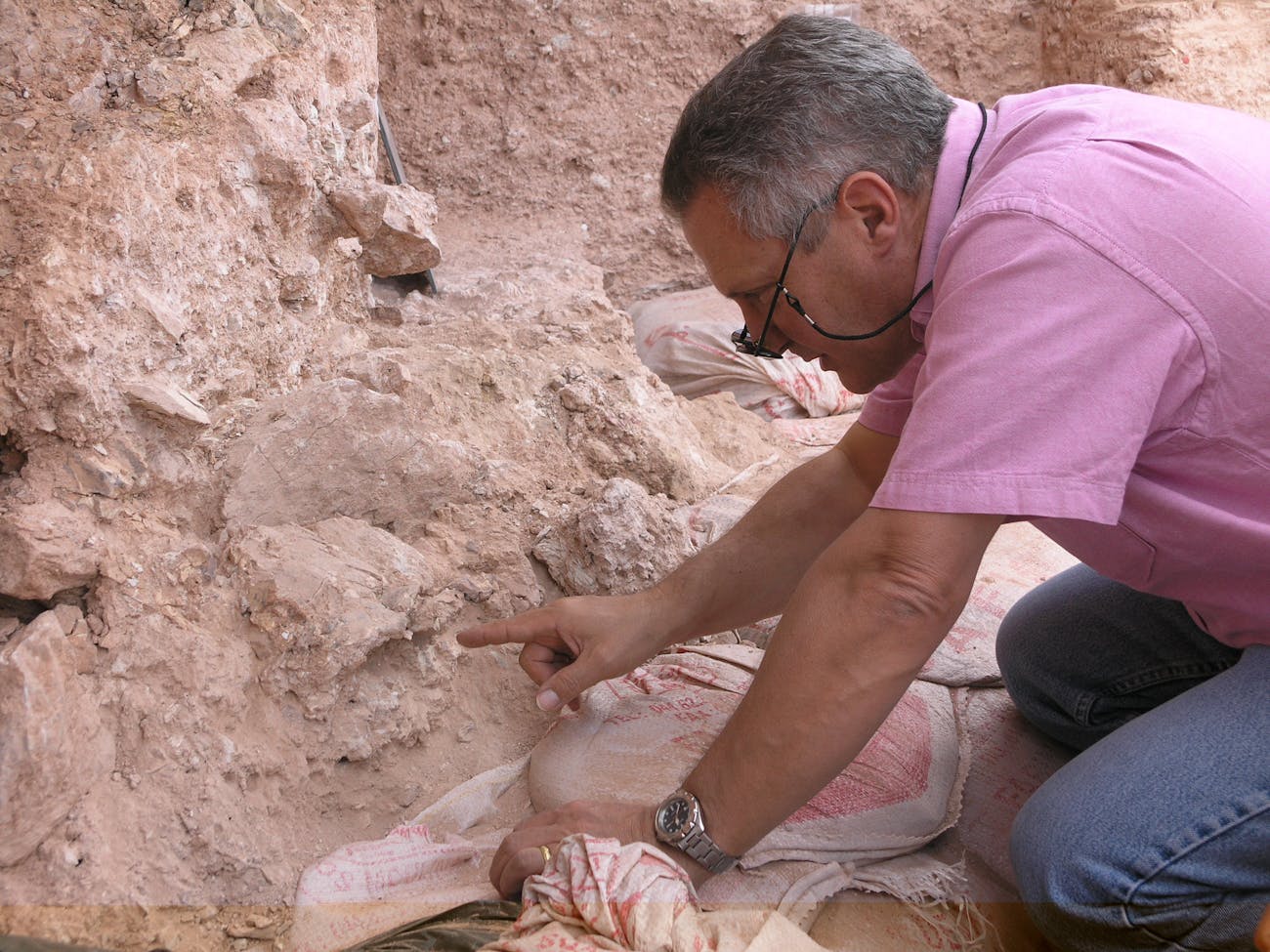 Dr. Jean-Jacques Hublin on first seeing the new finds at Jebel Irhoud (Morocco). He is pointing to the crushed human skull (Irhoud 10) whose orbits are visible just beyond his finger tip (Picture credit: Shannon McPherron, MPI EVA Leipzig, License: CC-BY-SA 2.0).