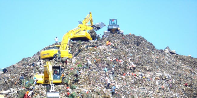 Mountain of garbage in Bantar Gebang with some excavator (Indonesia).