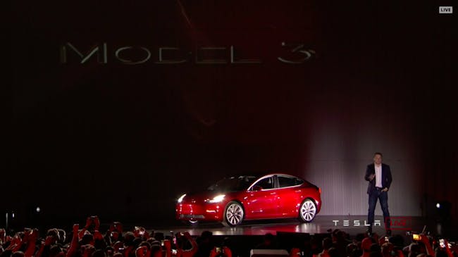 Elon Musk shows off the Tesla Model 3.