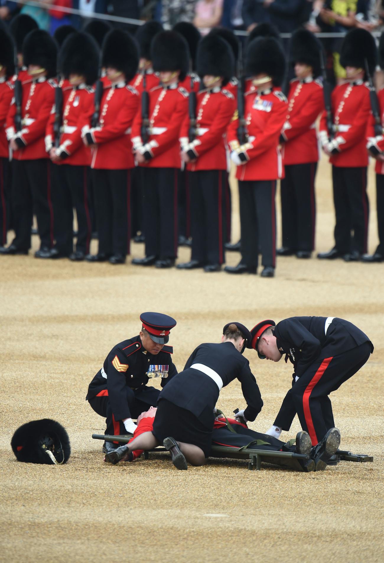 A guard of honor passes out as Queen Elizabeth II rides past