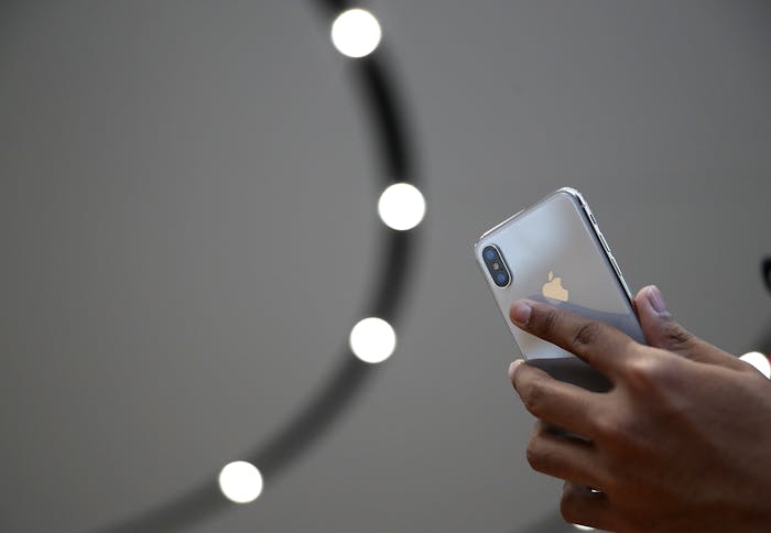 An attendee looks at a new iPhone X during an Apple special event at the Steve Jobs Theatre on the Apple Park campus on September 12, 2017, in Cupertino, California.