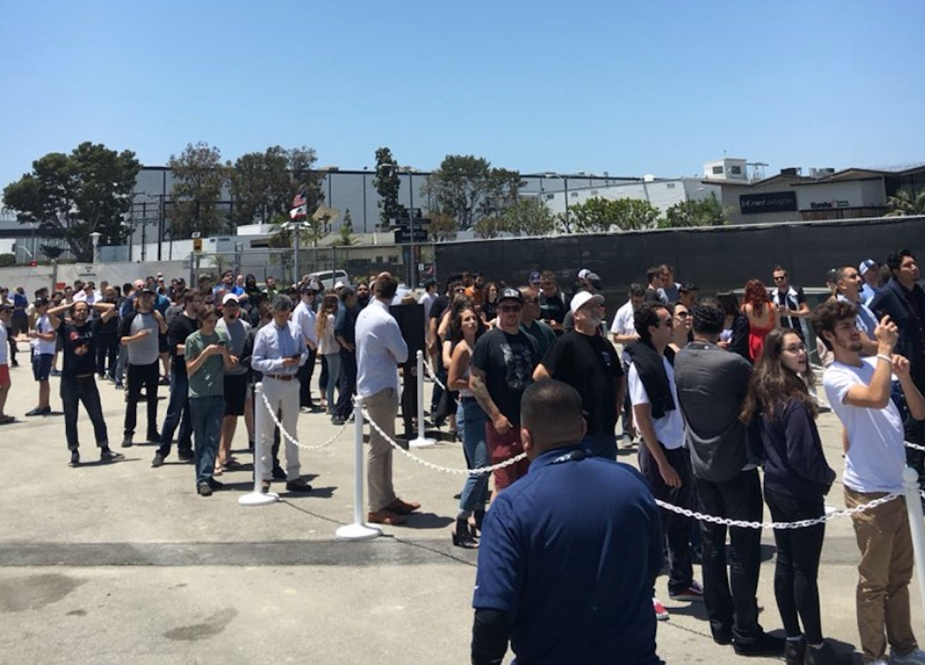 People lined up to receive flamethrowers.