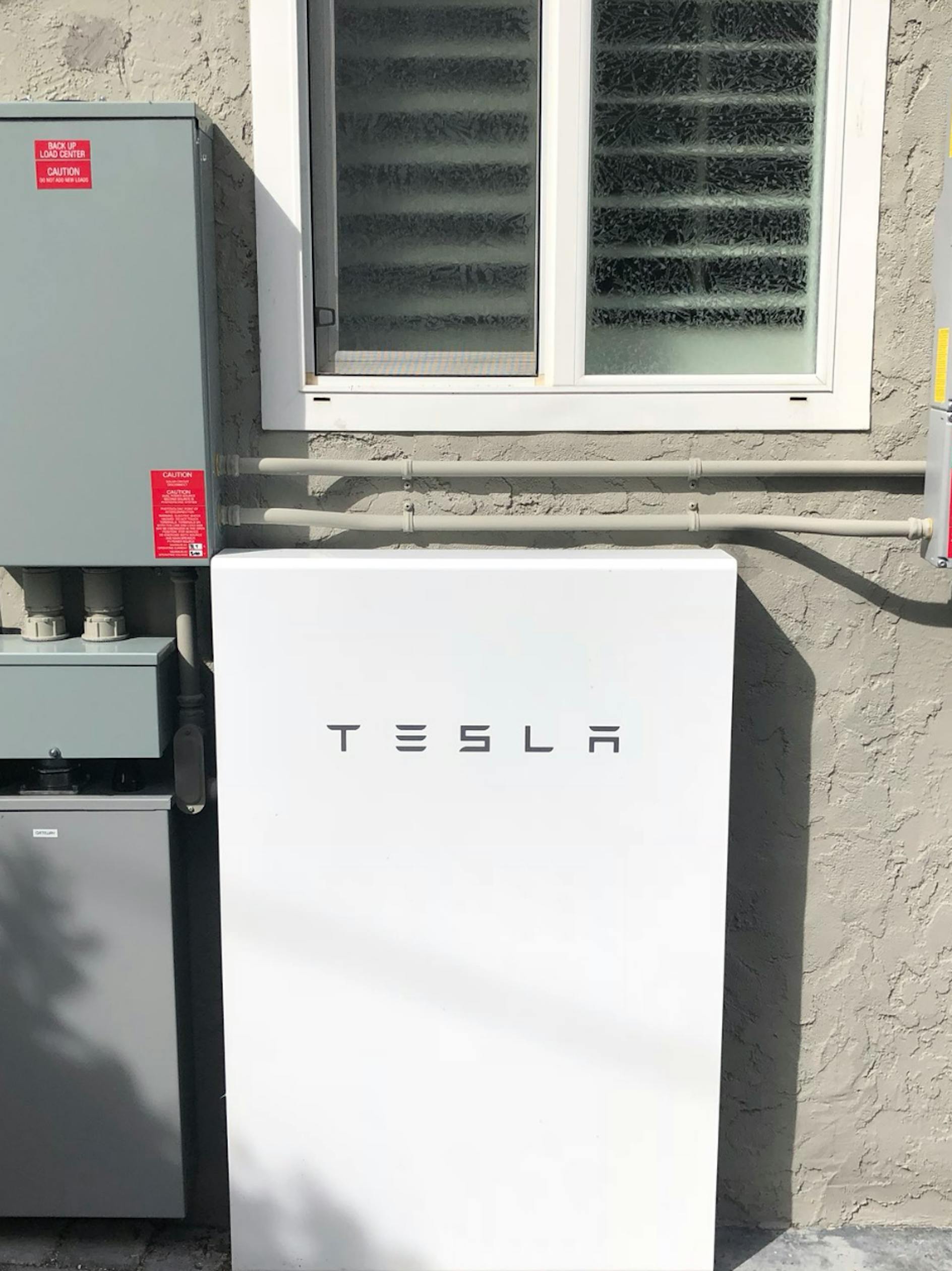 Tobler's Tesla Powerwall on the side of her house.