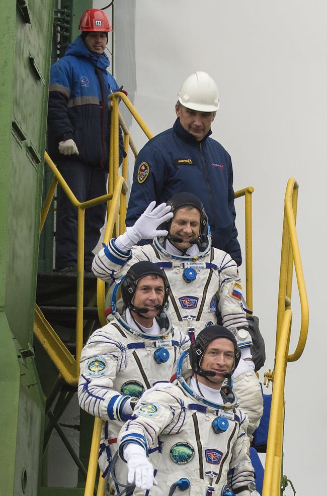 Expedition 49 flight engineer Andrey Borisenko of Roscosmos, flight engineer Shane Kimbrough of NASA, and Soyuz commander Sergey Ryzhikov of Roscosmos, climb the ladder to the elevator as they prepare to board the Soyuz MS-02 rocket for launch, Wednesday, Oct. 19, 2016 at the Baikonur Cosmodrome in Kazakhstan. Kimbrough, Borisenko, and Ryzhikov will spend the next four months living and working aboard the International Space Station.