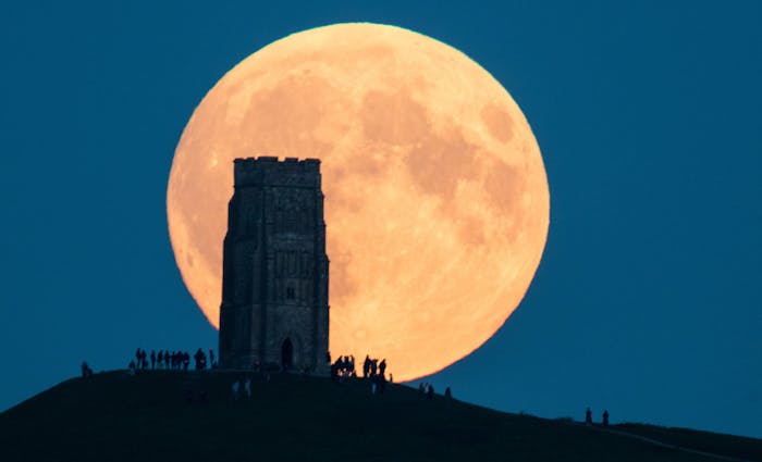 The supermoon rises behind Glastonbury Tor on September 28.