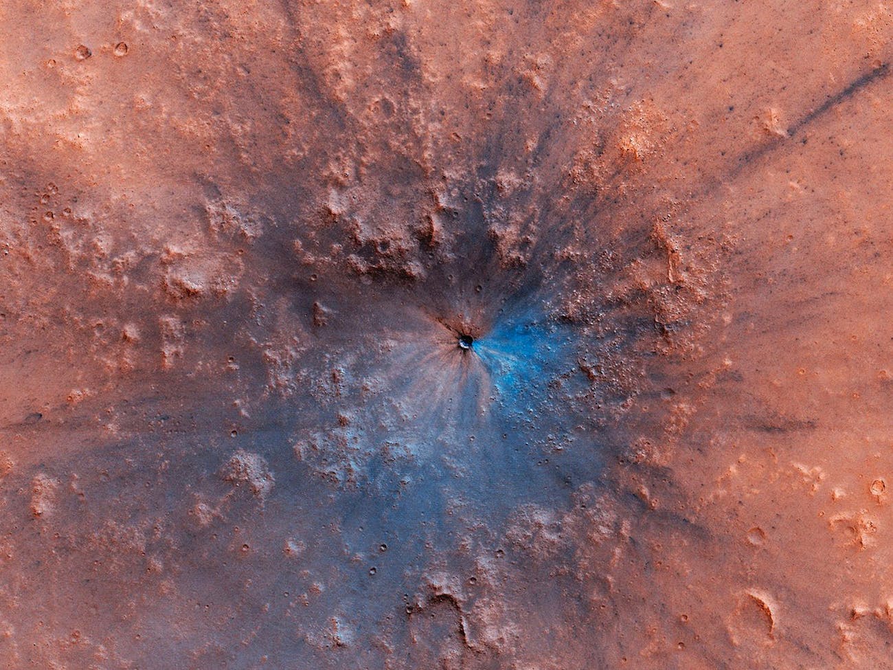 The exact nature of the geography in this region is still uncertain, but just below the surface is probably basalt, and the blue could even be some ice that was just under the surface.