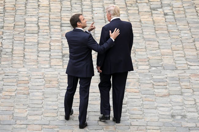 PARIS, FRANCE - JULY 13: French President Emmanuel Macron welcomes US President Donald Trump at Les Invalides As part of the commemoration of the 100th anniversary of the entry of the United States of America into World War I on July 13, 2017 in Paris, France. US President, Donald Trump will attend a military parade during Bastille Day. (Photo by Pierre Suu/Getty Images)