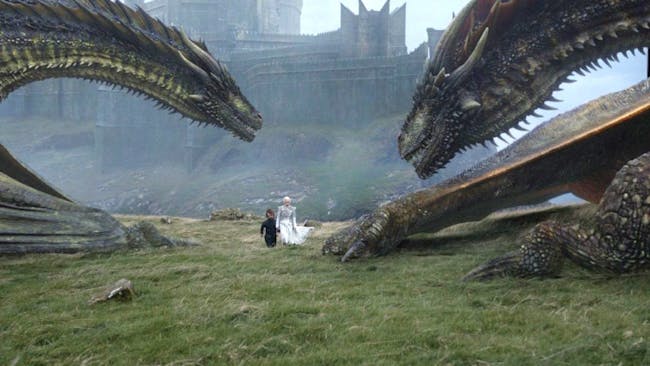 On Dragonstone, Tyrion and Daenerys walk near Rhaegal and Viserion.
