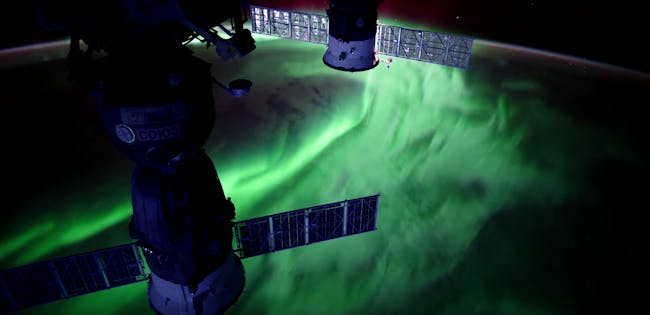 When charged particles from the sun interact with Earth's magnetic field, they produce dazzling auroras.