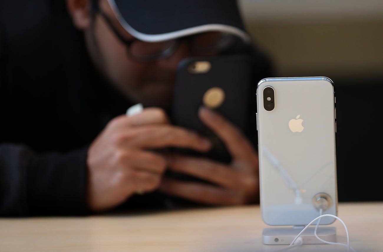 A customer takes a picture of the new iPhone X at an Apple Store on November 3, 2017 in Palo Alto, California.