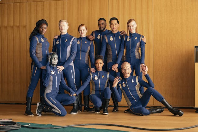 From left to right: Oyin Oladejo as Joann Owosekun; Sara Mitich as Airiam; Anthony Rapp as Paul Stamets; Mary Wiseman as Sylvia Tilly; Sonequa Martin-Green as Michael Burnham; Ronnie Rowe as Bryce; Patrick Kwok-Choon as Rhys; Doug Jones as Saru; Emily Coutts as Keyla Detmer