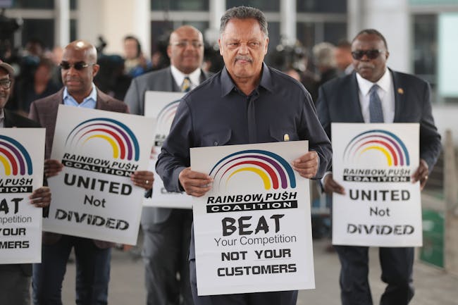 Civil rights leader Reverend Jesse Jackson leads a small group from the Rainbow PUSH Coalition in a protest outside the United Airlines terminal at O'Hare International Airport on April 12, corporate image after a cell phone video was released showing a passenger being dragged from his seat and bloodied by airport police after he refused to leave a reportedly overbooked flight that was preparing to fly from Chicago to Louisville.